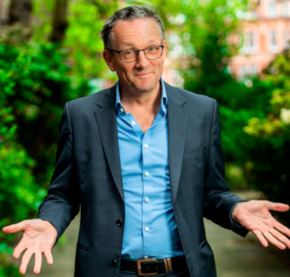 Dr Michael Mosley in suit with upturned hands